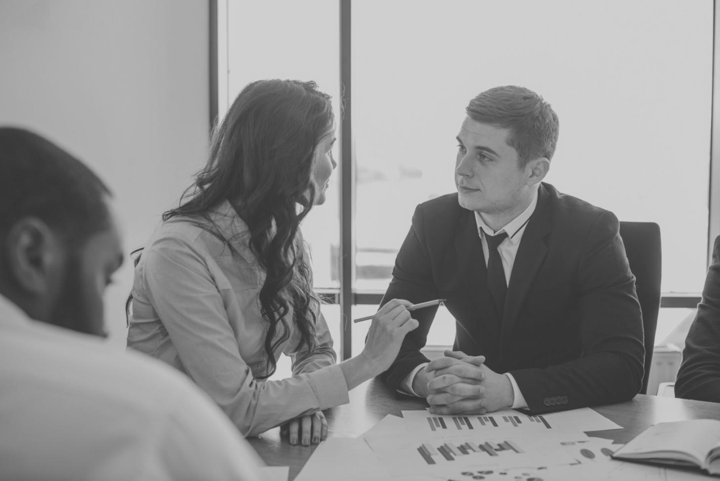 Professional business planning session with documents and charts